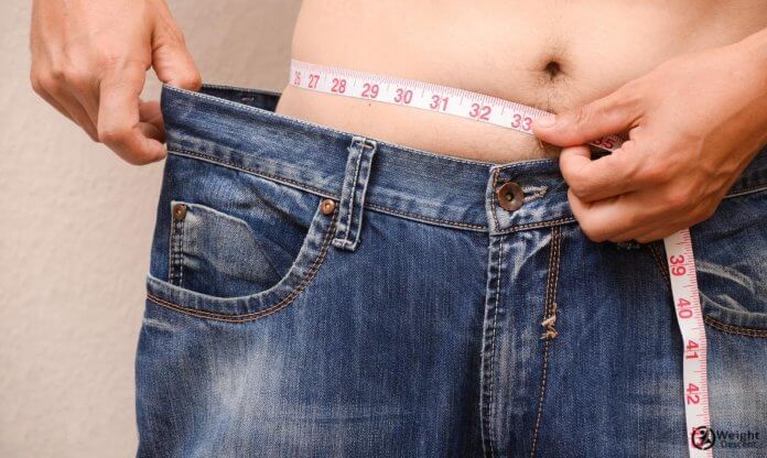 Man measuring belly