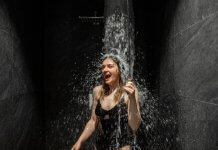 Woman taking cold shower