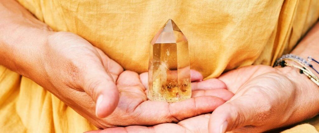 holding Citrine crystal in hand