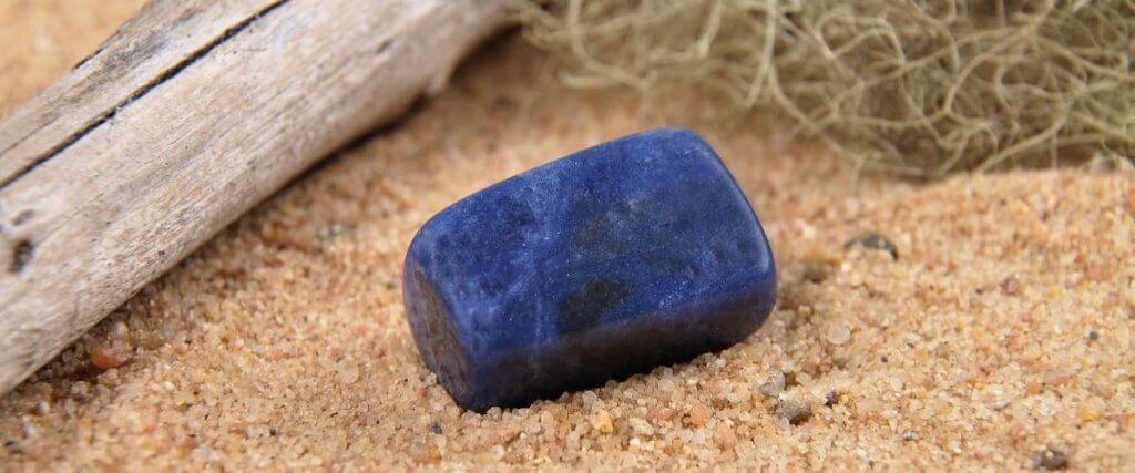 a photo of Sodalite crystal in sand