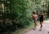 photo of two woman running in nature